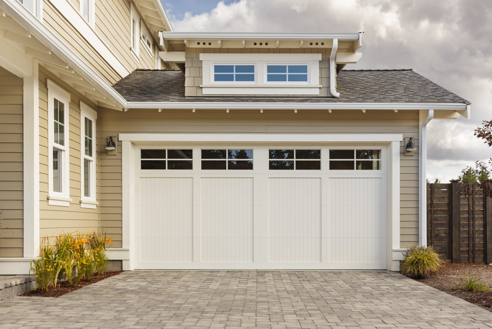 White,garage,door,with,a,driveway,made,with,brick